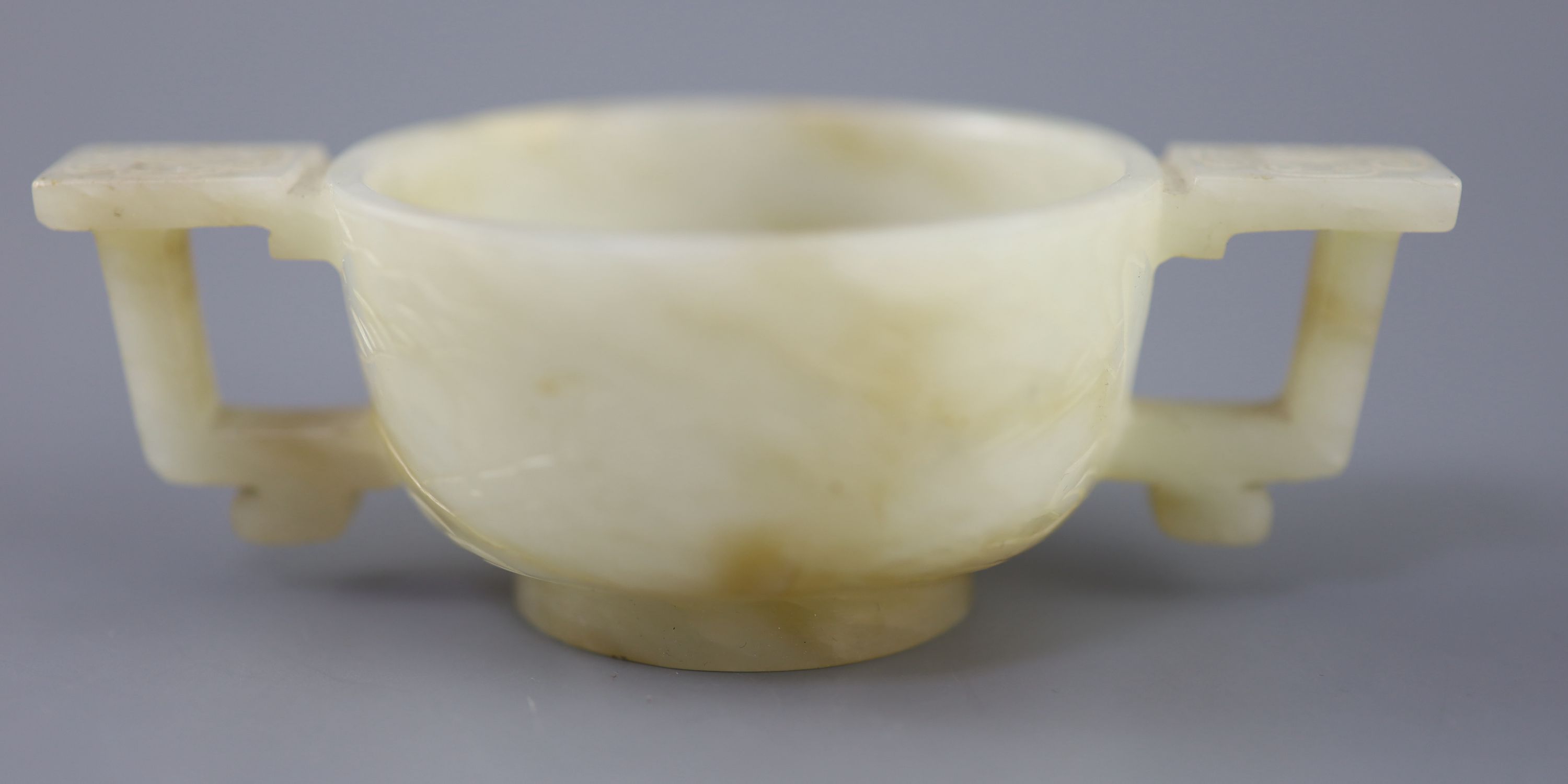 A Chinese pale celadon and russet jade cup, 17th/18th century, 12.5cm wide